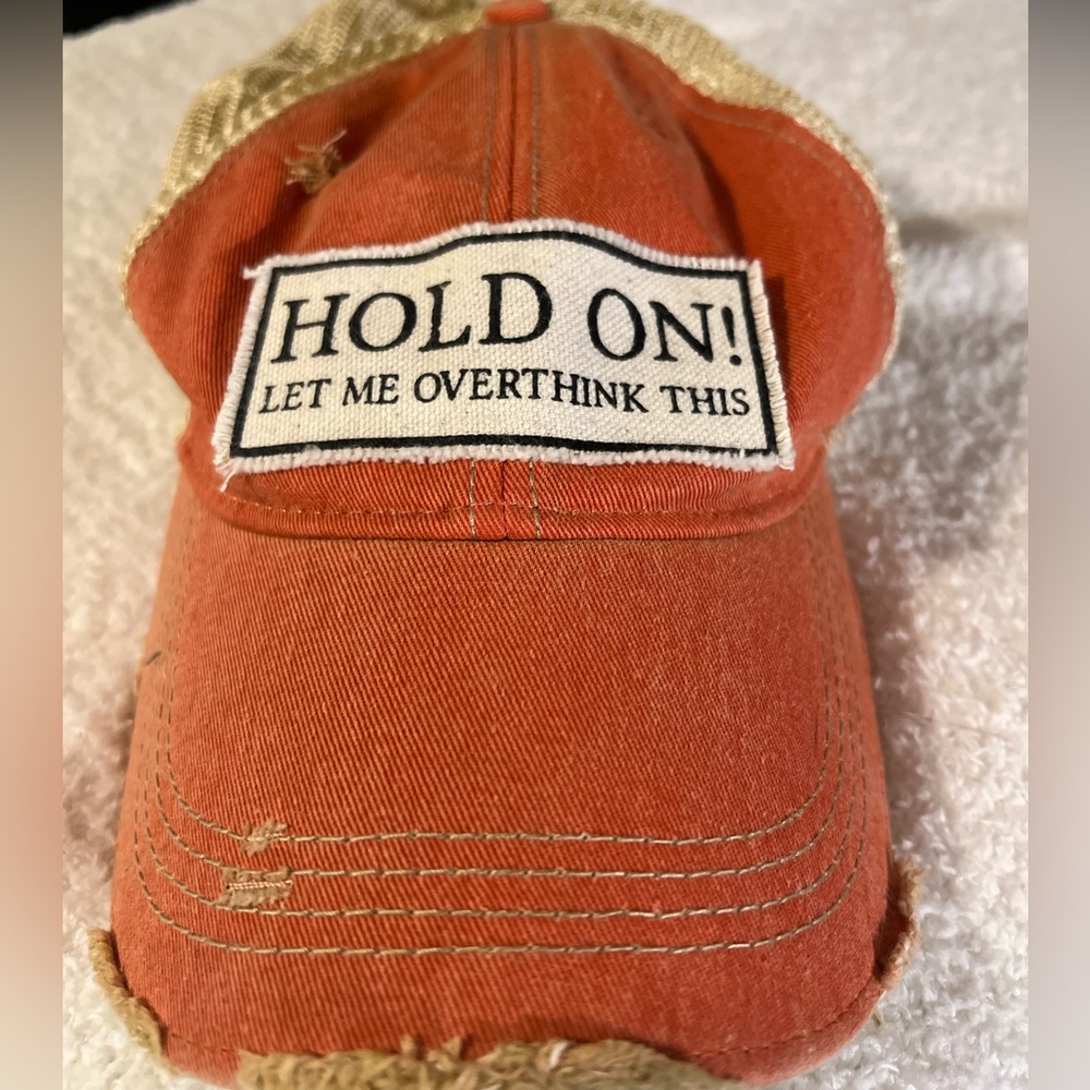 Faux distressed trucker hat orange and cream with green under. Work twice.